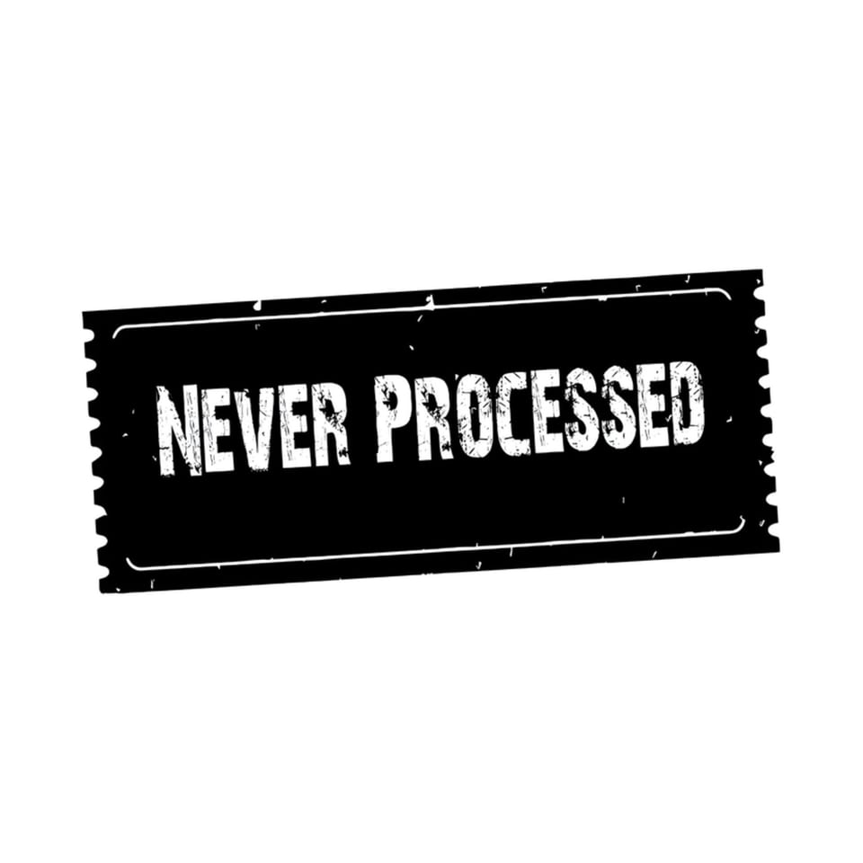 A black rectangular stamp with jagged edges reads "NEVER PROCESSED" in distressed white letters.