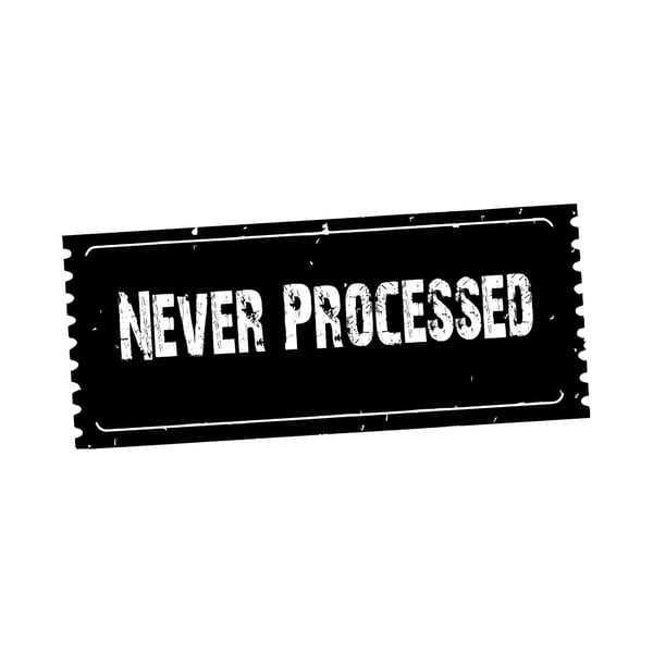 A black rectangular stamp with jagged edges and the white text "NEVER PROCESSED".